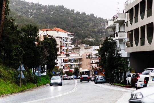 Road in Kavala Greece After Rain with City Slope and Traffic