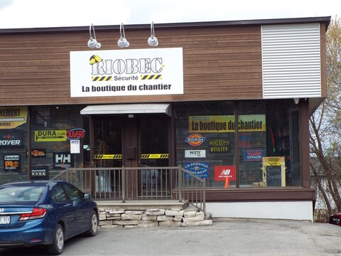 Gatineau, Quebec, Canada &ndash; May 2, 2026: Exterior view of the "Riobec S&eacute;curit&eacute;" storefront, displaying various workwear brand logos in the window at 540 Boulevard Saint-Joseph.