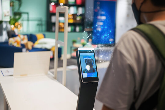 Facial recognition biometric terminal scanning a person for security access.