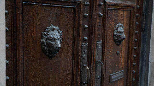Ornate Bronze Lion Head Door Knockers on Antique Studded Wooden Doors, Masonic Temple