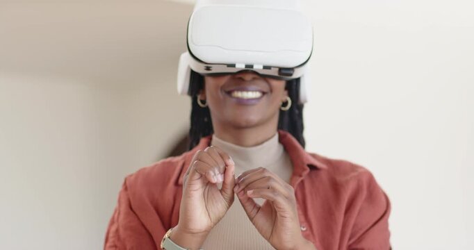 African American woman wearing VR headset responding to prompt and pinching virtual objects at home