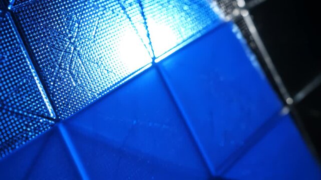 Closeup of perforated metal mesh with light perfect for UI/UX elements and digital motion graphics