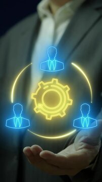 Teamwork concept, collaborative effort of a group to achieve a common goal or to complete a task in an effective and efficient way. Businessman shows glowing neon line of Teamwork icon on virtual.