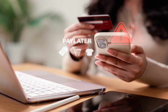 Danger of paylater debt trap and financial risk in online shopping. Woman holding smartphone and credit card with red warning alert.