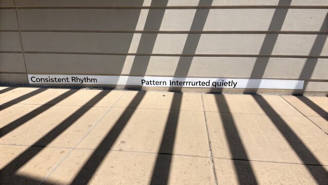 Repeating Shadows on Textured Wall and Pavement