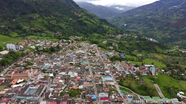 Aerial drone forward tracking over Choachi town in green mountain valley