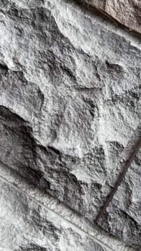 Close-up natural quartz facade panels showcasing rugged stone texture and modular layout, detailed grain and chiseled seams