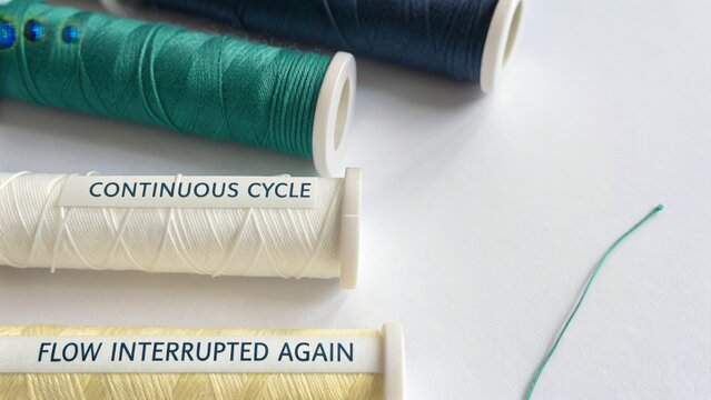 Spools of thread in various colors on a clean surface