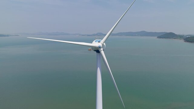 Aerial Close-up Pullback from Wind Turbine Generator over Sea near Nue Island in South Korea