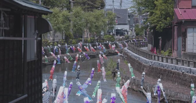 Carp streamers swaying in the wind near the brook at the traditional town