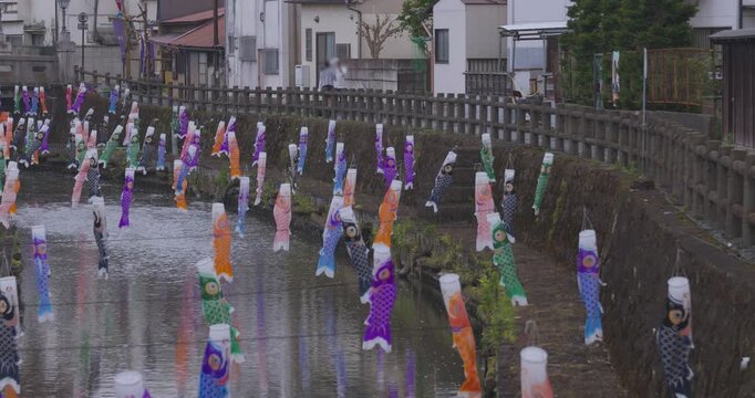 Carp streamers swaying in the wind near the brook at the traditional town