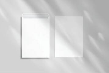 Naklejka premium White mailing envelope mockup with elegant organic shadow overlay isolated. minimal stationery packaging template for business correspondence, branding, print design, and postal presentation.
