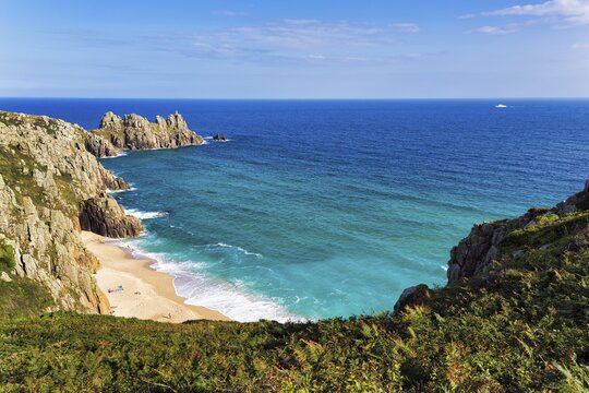 Treen cliffs and Pedn Vounder beach, South West Coast Path, coastline at Treen, Scilly ferry on horizon, St Levan, Penwith, Cornwall, England, United Kingdom