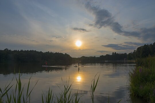 Calm lake at sunset, surrounded by trees and reeds, with a clear sky and scattered clouds, Ole&scaron; pond at sunset, Ole&scaron;sk&yacute; rybn&iacute;k, Star&aacute; Ole&scaron;ka, village Hunt&iacute;rov, districtDec&iacute;n, &Uacute;steck&yacute; kraj, region &Uacute;st&iacute; nad Labem, Bohemian Switzerland, Elbe Sandstone Mountains, Czech Republic