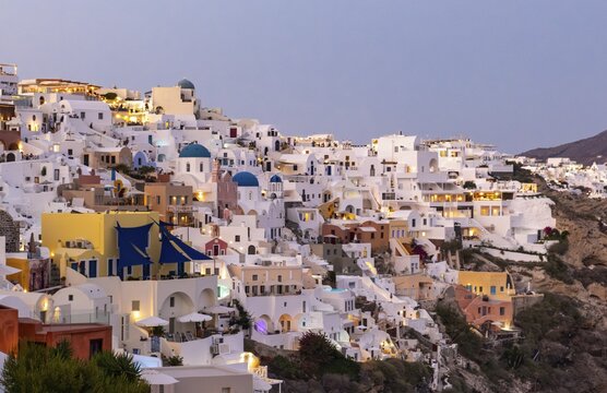 View of village of Ia from Oia castle at dusk, Santorini, Thira, Greece
