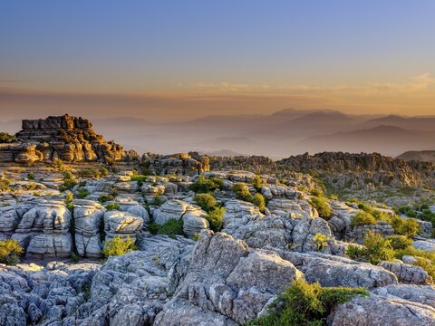 Limestone rock formations at sunset, El Torcal nature reserve, Torcal de Antequera, Malaga province, Andalusia, Spain