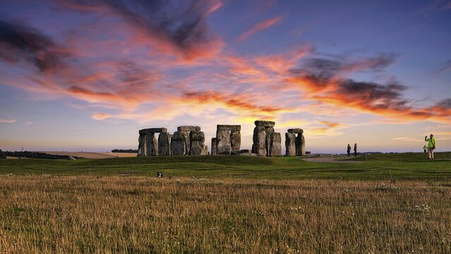 Stonehenge, Neolithic stone circle with visitors at sunset, Salisbury Plain, Wiltshire, England, United Kingdom