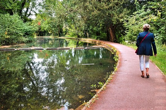 Woman walking along canal path, The Rye, HIgh Wycombe, Buckinghamshire, England