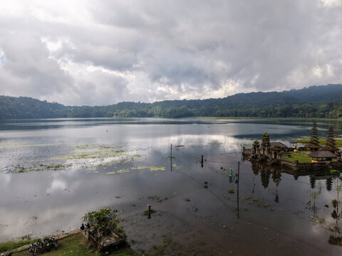 Scenic View of Lake Tamblingan with Pura Ulun Danu Tamblingan Hindu Temple under Cloudy Sky, Bali, Indonesia