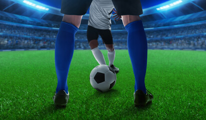 Fototapeta premium Two professional soccer player legs, blue team and white team in the stadium field