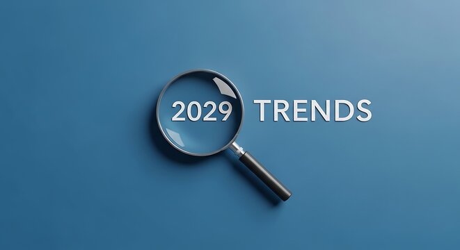 Magnifying glass placed over 2029 trends text on blue background for business planning and market research with magnifying