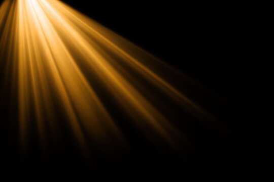 Golden light beams radiating against a dark background.