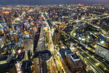 Fototapeta premium Nagoya central business district skyline on the evening, modern skyscrapers, roads and railways under twilight sky.