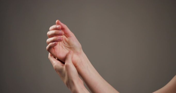 Close-up of two human hands gently holding each other, showing care and comforting