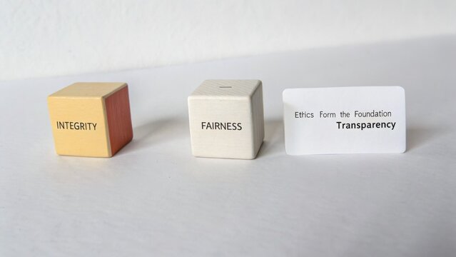 Wooden blocks with words representing core values such as integrity, fairness, ethics, and transparency on a clean surface for conceptual imagery