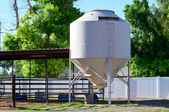 Feed storage bin at a small private ranch farm, representing agricultural infrastructure, livestock operations, and rural property management