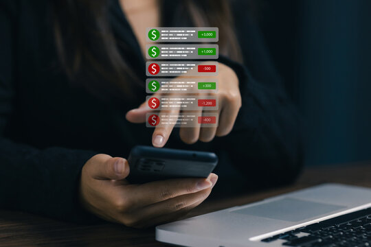 Businesswoman using smartphone with digital financial transaction notifications, mobile banking alerts and online payment activity. Fintech, expense tracking and cash flow management concept.