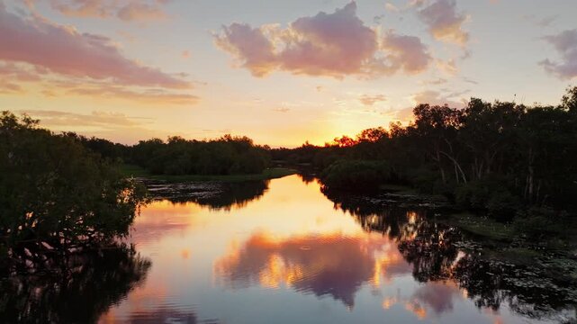 Aerial River Reflecting Vivid Pink Orange Cloudy Sunset Yellow Water Billabong Kakadu Australia