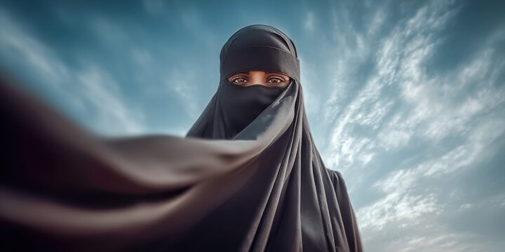Portrait of a woman wearing a black niqab against a dramatic cloudy sky