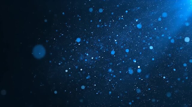 Blue glowing particles floating in a dark space with a soft light beam from the corner
