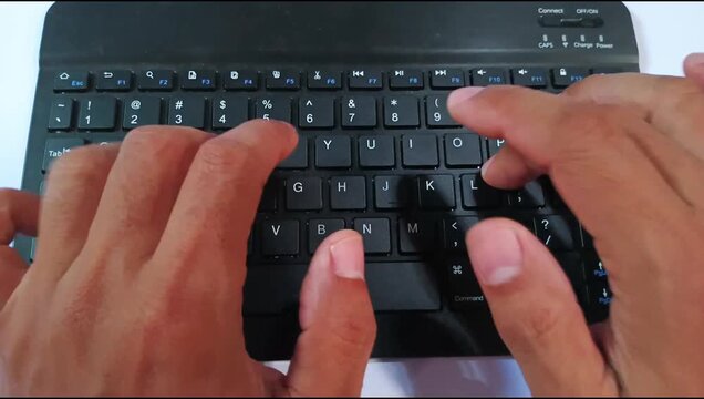 Close-up footage of human hands typing on a laptop keyboard. Suitable for technology, office work, online business, remote working, programming, blogging, communication, and digital lifestyle concepts