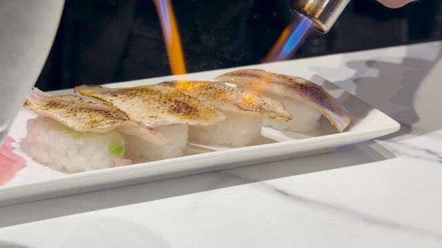 Chef Searing Fresh Nigiri Sushi with a Blowtorch in Kanazawa Japan