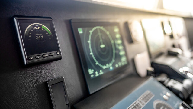 Digital compass navigation and depth monitor on dashboard of marine boat. Nautical vessel control system in wheelhouse or ship captain bridge. Modern boating technology