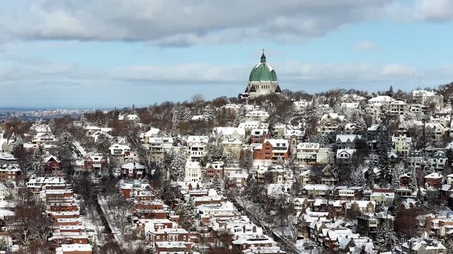 Saint Josephs Oratory dome above snowy Westmount and Montreal neighborhood on Mount Royal hill in winter, Quebec, Canada. g.