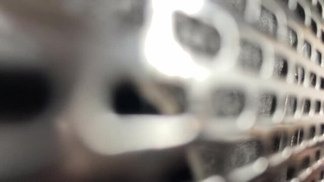 4K push in shot of blurred active speaker texture Abstract close up of audio equipment and grill cloth background loop perfect for music technology and hifi sound system broll footage