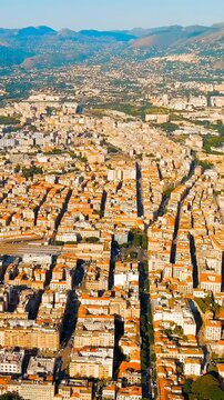 Vertical video. Palermo, Sicily, Italy. Palermo Centrale railway station, monumental eclectic facade, aerial panoramic view over the historic city center and surrounding mountains. Drone footage. Ric