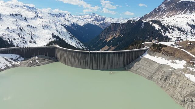 Aerial Establishing Hydroelectric Dam in Snowy Alpine Landscape