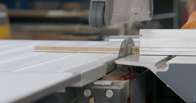 Slow motion Closeup of table saw cutting a slab of wood