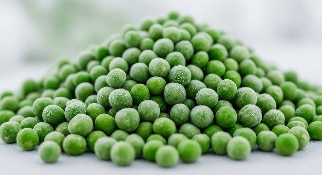 Heap of frozen organic green peas with ice crystals