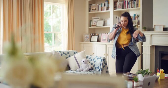 Singing, dancing and happy woman with remote in home for good mood, positive energy and karaoke. Weekend, living room and person with lyrics for music, audio and playlist for groove, moving and fun