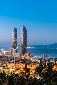 Night coastline scenery of twin towers and Yanwu bridge in Xiamen, Fujian, China