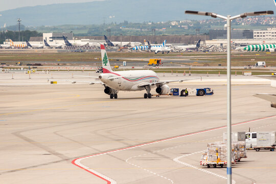 Middle East Airlines (MEA) Airbus A320 Being Towed on the Apron at Frankfurt Airport with Distant Aircraft and Taunus Hills