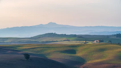 Fototapeten Toskana Beautiful sunrise landscape of Tuscany rolling hills with morning fog and distant mountains, Italy  © Aekachai