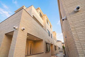 Fototapeta premium White security cameras mounted on a brick exterior