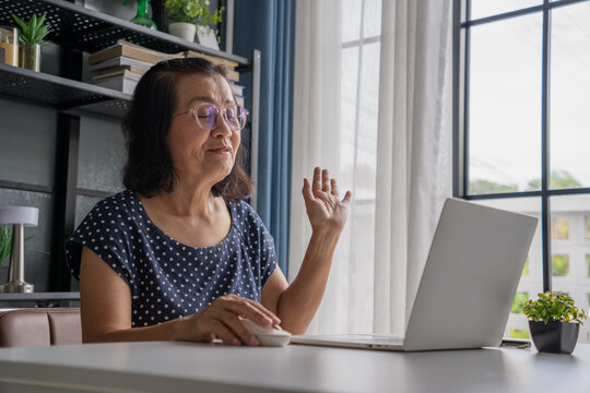 Senior Asian woman Use a laptop for VDO Call Conference