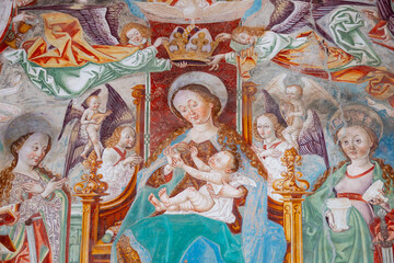 Fototapeta premium Fresco of Blessed Virgin Mary holding baby Jesus Christ in her arms.